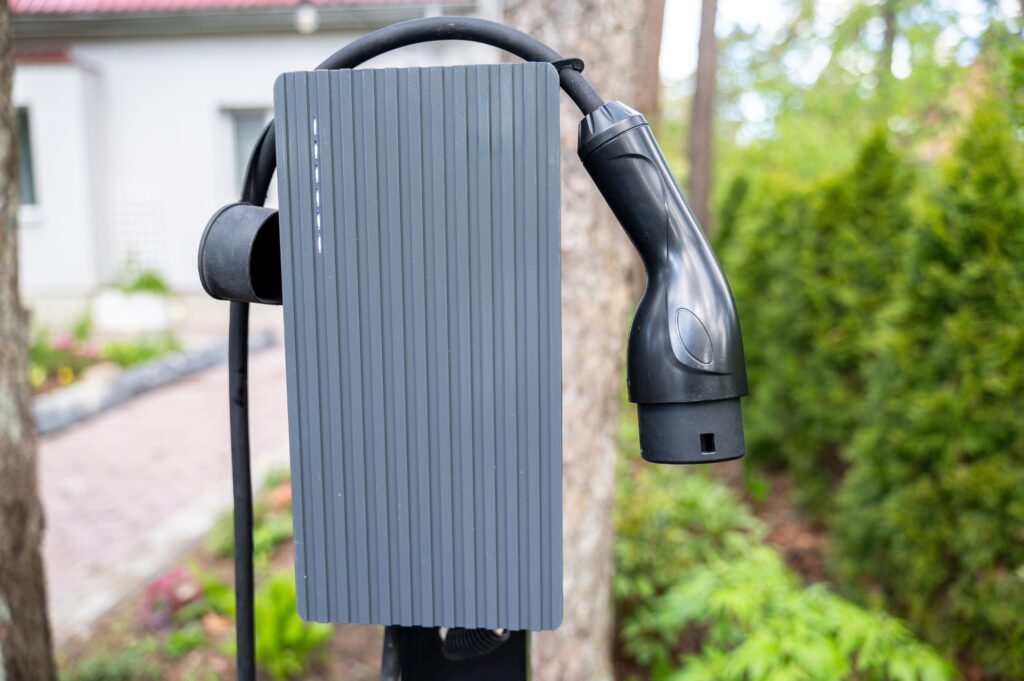 close up,view,of,electric,vehicle,charger,mounted,outdoors,in,home close up,view,of,electric,vehicle,charger,mounted,outdoors,in,home